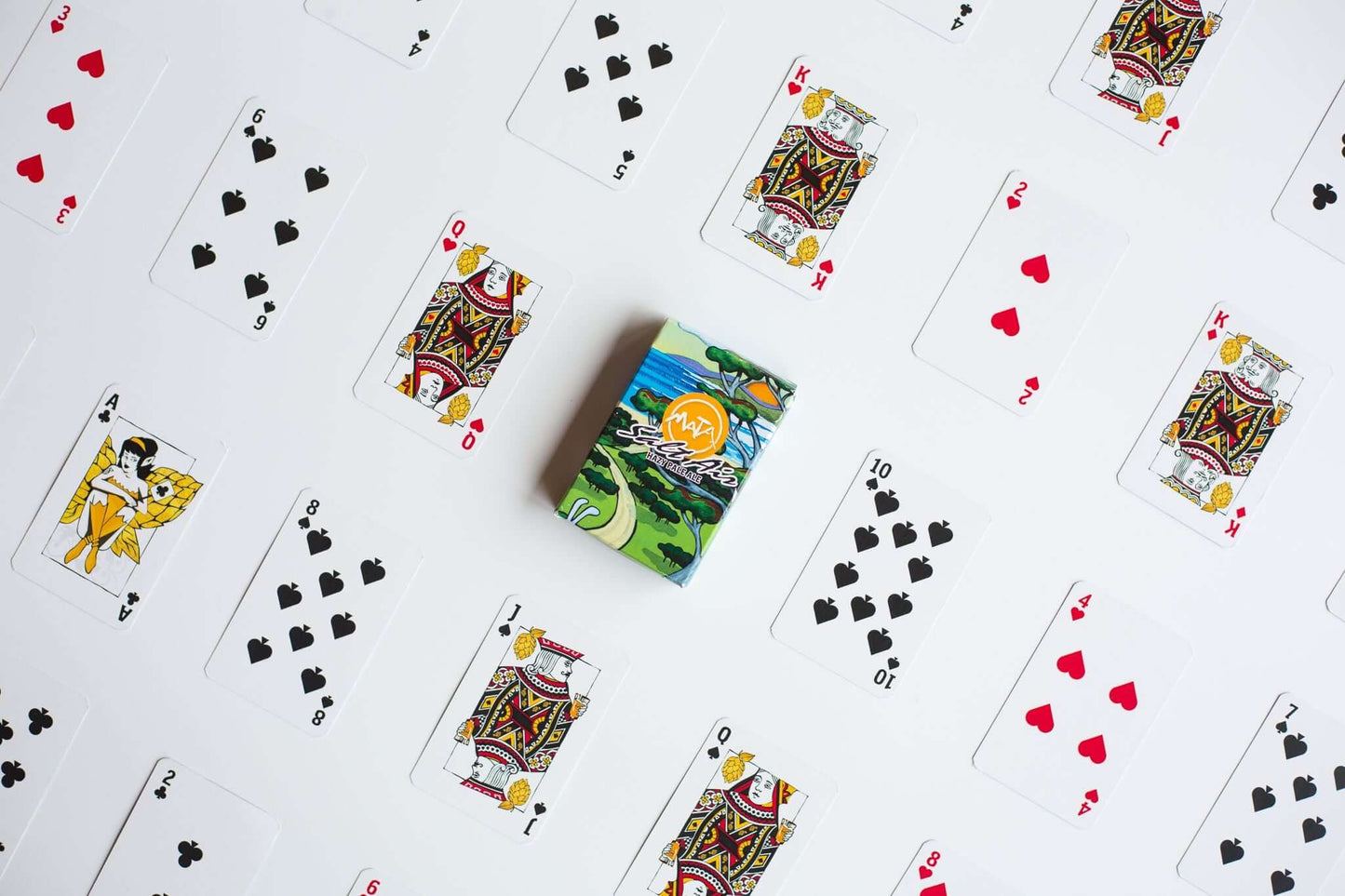 Custom poker-sized playing cards spread with a printed box in the center.